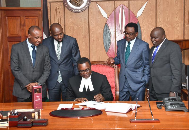 Speaker of the Senate, Rt Hon Kenneth Lusaka signs Suit Papers in the Presence of then-House Leadership and Chair Justice - Legal Affairs | July 2019